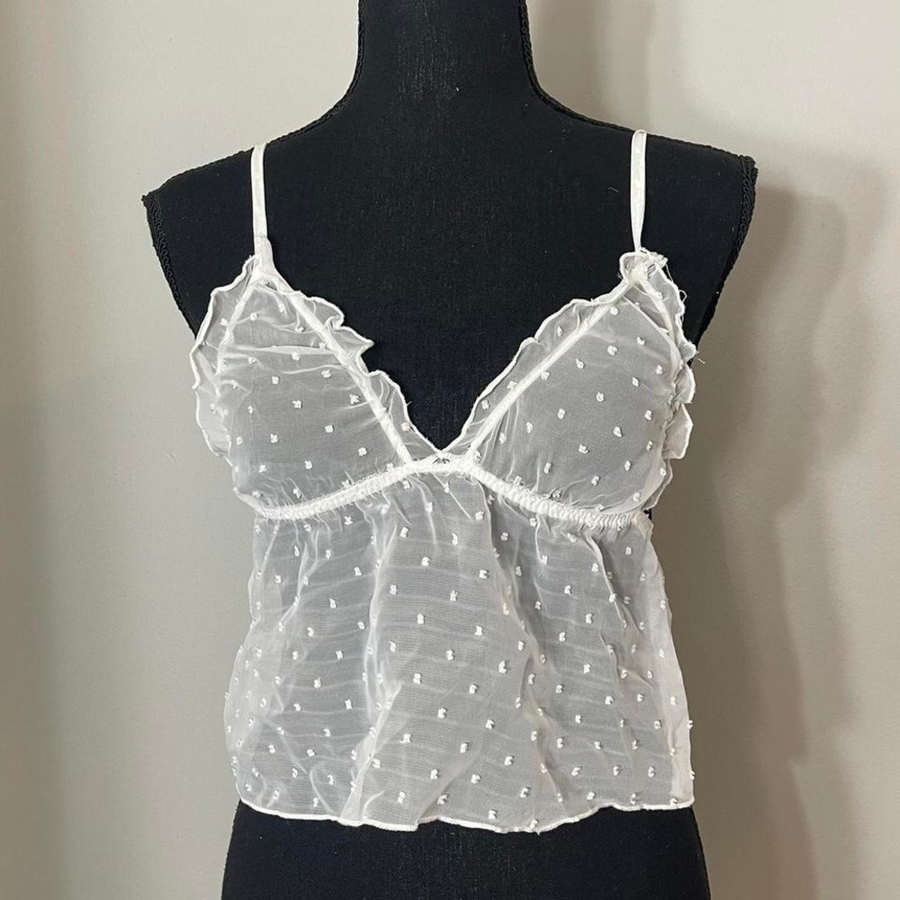 White sheer polka dot cami top with ruffle trim and adjustable straps